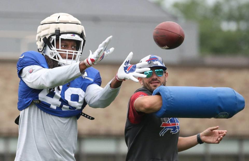 Bills linebacker Tremaine Edmunds (49) eyes in the ball as he is hit by linebackers coach Bobby Babich during interception drills on day nine of Buffalo Bills training camp at St. John Fisher University in Rochester Thursday, Aug. 4, 2022.

Sd 080422 Bills Camp 12 Spts