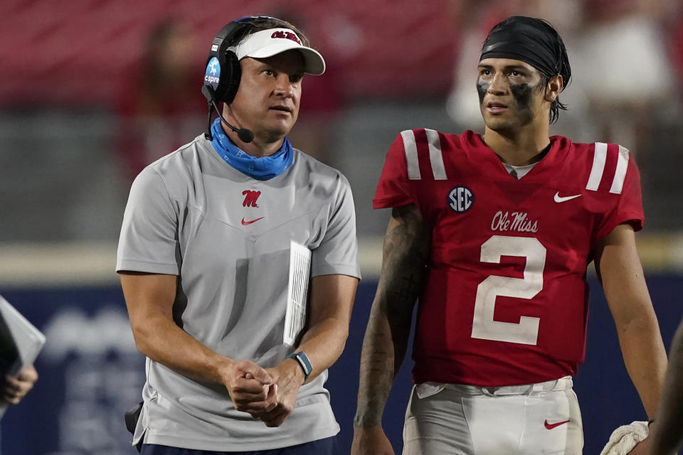 Mississippi head coach Lane Kiffin confers with quarterback Matt Corral (2) during the second half of the team's NCAA college football game against Tulane on Saturday, Sept. 18, 2021, in Oxford, Miss. Mississippi won 61-21. (AP Photo/Rogelio V. Solis)