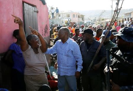 A woman reacts as Haiti's Interim President Jocelerme Privert (C) visits after Hurricane Matthew passes in Jeremie, Haiti, October 8, 2016. REUTERS/Carlos Garcia Rawlins