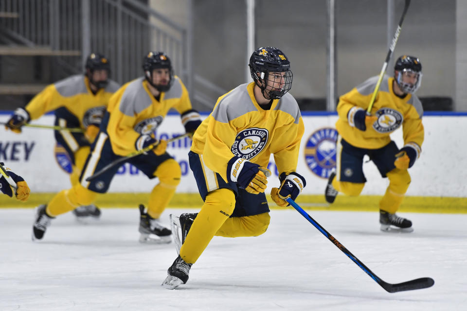 Canisius left wing Alton McDermott, second from right, skates during an NCAA college hockey practice in Buffalo, N.Y., Thursday, Jan. 26, 2023. McDermott's grandfather, former NHLer Paul Henderson, scored the decisive goal in clinching Canada its Summit Series win over Russia some 50 years ago and will celebrate his 80th birthday with a ceremonial puck drop before Cansius' game against Niagara. (AP Photo/Adrian Kraus)
