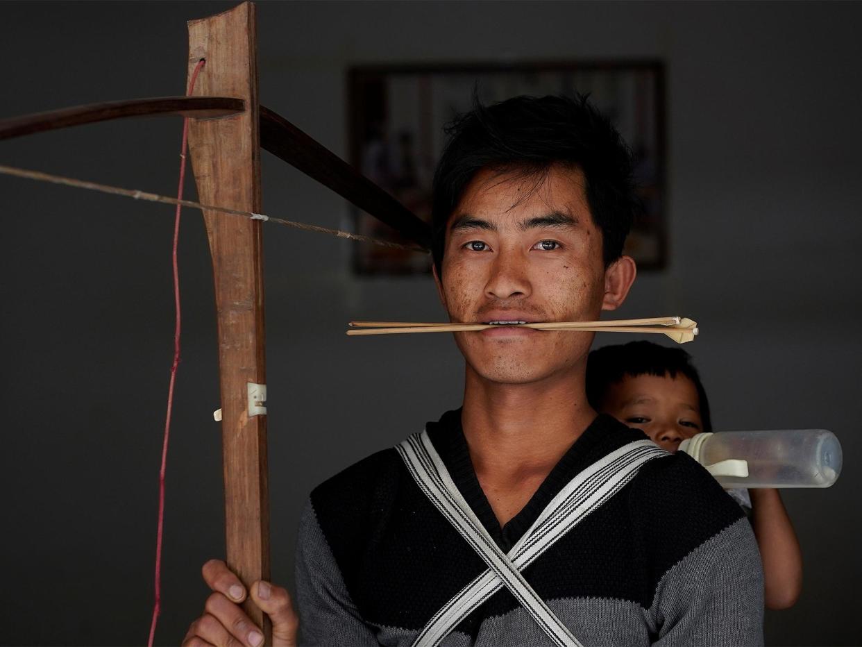 Secret weapons: Zhang and other tribe members are aiming to save the tradition, which dates back to 200BC, by promoting it as a sport: Reuters