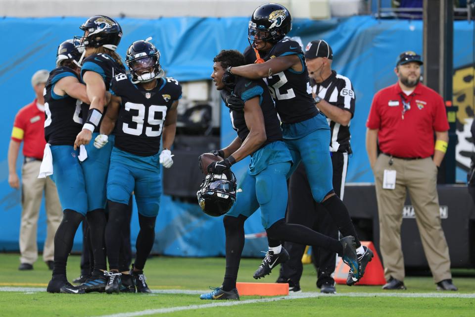 Jaguars wide receiver Zay Jones (7) is hugged by teammate Tyson Campbell (32) after scoring a two-point conversion on Nov. 27, 2022 at EverBank Stadium to beat the Ravens 28-27.
