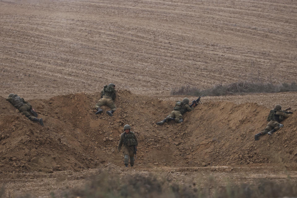 Israeli soldiers take position near the Israeli Gaza border, southern Israel, Monday, Oct. 9, 2023. The militant Hamas rulers of the Gaza Strip carried out an unprecedented, multi-front attack on Israel at daybreak Saturday, firing thousands of rockets as dozens of Hamas fighters infiltrated the heavily fortified border in several locations, killing hundreds and taking captives. Palestinian health officials reported scores of deaths from Israeli airstrikes in Gaza. (AP Photo/Oren Ziv)