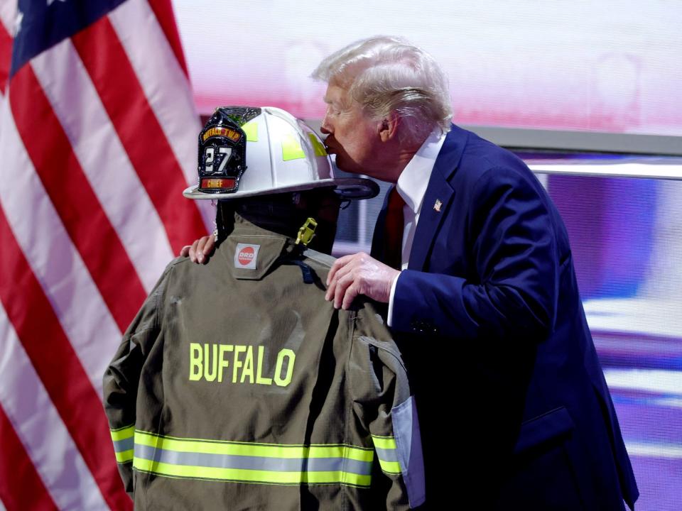 Trump embraces fire gear belonging to Corey Comperatore, the man killed at the Pennsylvania rally.