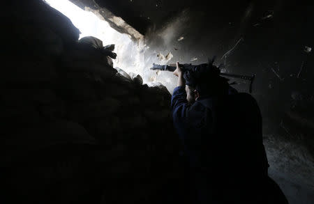 A rebel fighter fires his weapon at the frontline against forces loyal to Syria's President Bashar al-Assad in al-Amriyah neighbourhood of Aleppo, October 11, 2014. REUTERS/Hosam Katan