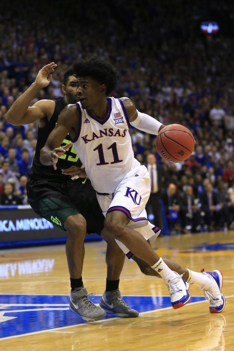 FILE - In this Feb. 1, 2017, file photo, Kansas guard Josh Jackson (11) drives against Baylor guard Al Freeman (25) during the first half of an NCAA college basketball game in Lawrence, Kan. Kansas coach Bill Self says star freshman Josh Jackson will play in the NCAA Tournament despite several off-the-court issues and allegations that Jackson and his representatives tried to bribe a student to make a vandalism accusation go away. (AP Photo/Orlin Wagner, File)