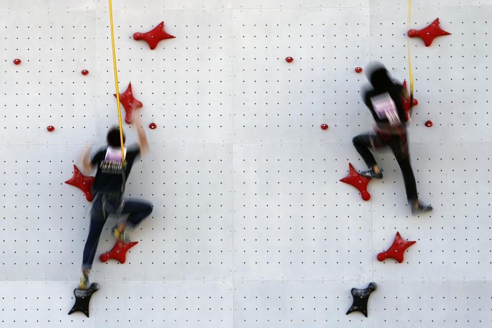 Tokyo 2020 Olympic Games Organizing staffs climb the wall in the test event of Speed Climbing in preparation for the Tokyo 2020 Olympic Games at Aomi Urban Sports Park Friday, March 6, 2020, in Tokyo. The recent outbreak of the coronavirus has forced them to cancel or postpone several. But they allowed a sport climbing event on Friday to go ahead, with a few restrictions: like the absence of elite athletes. (AP Photo/Eugene Hoshiko)