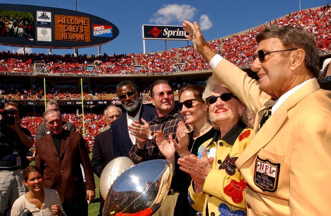 Former Kansas City Chiefs head coach Hank Stram, right, waves to Chiefs fans after Stram was inducted to the Pro Football Hall of Fame. He once coached the Chiefs against the Denver Broncos at Farrington Field. (Kansas City Star archives)