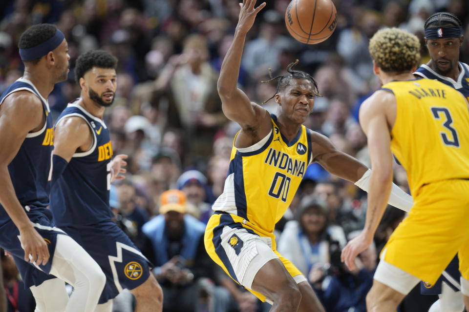 Indiana Pacers guard Bennedict Mathurin (00) reacts after losing control of the ball as Denver Nuggets forward Bruce Brown, guard Jamal Murray and forward Zeke Nnaji, from left, defend during the second half of an NBA basketball game Friday, Jan. 20, 2023, in Denver. Pacers guard Chris Duarte is at front right. (AP Photo/David Zalubowski)