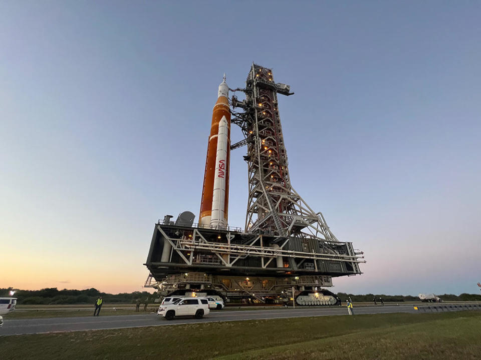 Another view of the SLS rocket and its mobile launch gantry being hauled from the Vehicle Assembly Building to launch pad 39B. / Credit: Miles Doran/CBS News