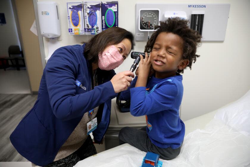 SANTA MONICA, CA - JANUARY 23: Dr. Alice Kuo, MD, PhD, professor and Chief of Medicine-Pediatrics at UCLA, doing a well child visit with 4-year-old patient JoJo at the UCLA Health System Medicine-Pediatrics Comprehensive Care Clinic Tuesday, Jan. 23, 2024 in Santa Monica, CA. California has some of the lowest rates of well child visits for kids 0-3 in the nation. That means kids aren't getting the care they need - from physicals to developmental screenings to immunizations. JoJo was with his mother Faye Holmes, 50, not shown, of Los Angeles. (Gary Coronado / Los Angeles Times)