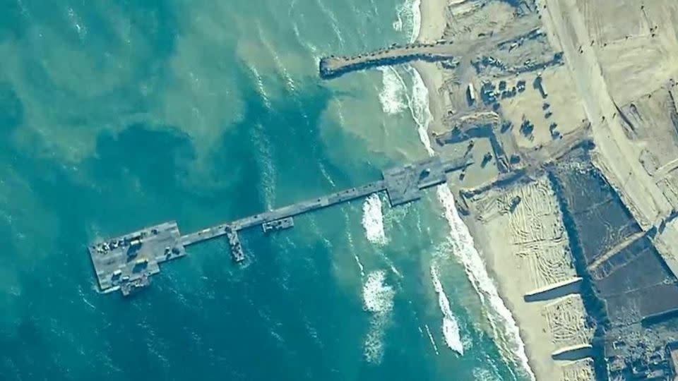 Members of the US Army, US Navy and the Israeli military put in place the Trident Pier, a temporary pier to deliver humanitarian aid, on the Gaza coast, on Thursday. - U.S. Central Command/Reuters