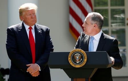 FILE PHOTO: U.S. President Donald Trump (L) listens to EPA Administrator Scott Pruitt after announcing his decision that the United States will withdraw from the Paris Climate Agreement, in the Rose Garden of the White House in Washington, U.S., June 1, 2017. REUTERS/Kevin Lamarque/File Photo