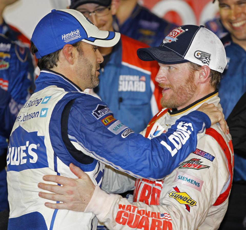 Dale Earnhardt Jr., right, celebrates in Victory Lane with teammate Jimmie Johnson, left, after winning the NASCAR Daytona 500 Sprint Cup series auto race at Daytona International Speedway in Daytona Beach, Fla., Sunday, Feb. 23, 2014. (AP Photo/Terry Renna)