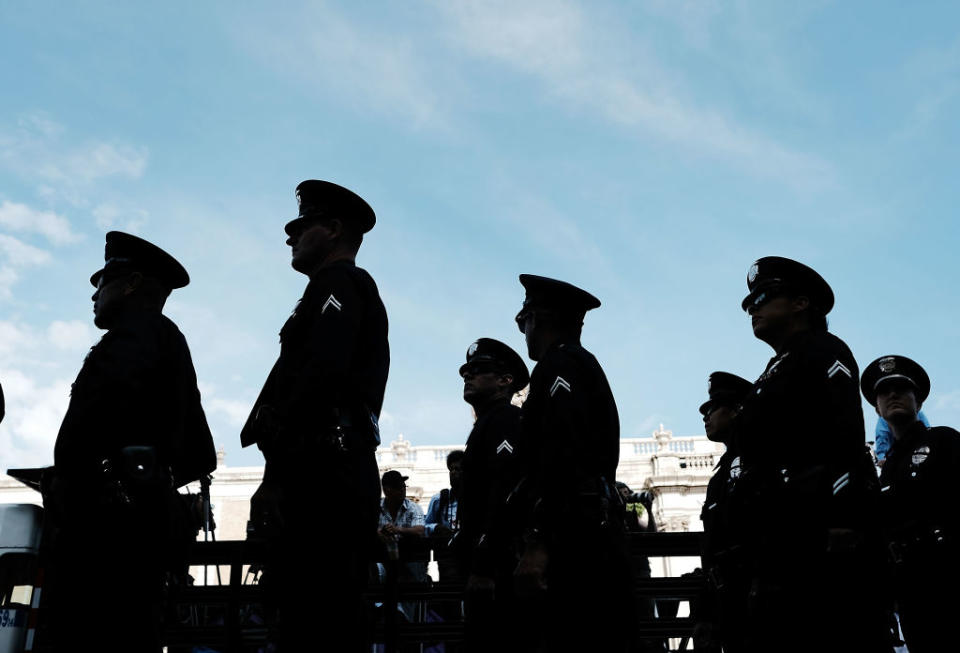 Police officers walk by. (Photo: Spencer Platt/Getty Images)