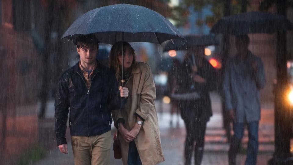 Daniel Radcliffe and Zoe Kazan share an umbrella i in the rain in "What If..."