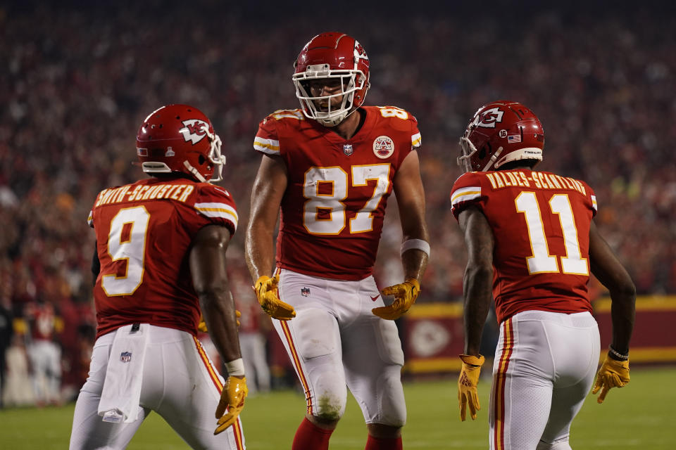 Kansas City Chiefs tight end Travis Kelce (87) is congratulated by teammates wide receivers JuJu Smith-Schuster (9) and Marquez Valdes-Scantling (11) after scoring during the first half of an NFL football game against the Las Vegas Raiders Monday, Oct. 10, 2022, in Kansas City, Mo. (AP Photo/Charlie Riedel)