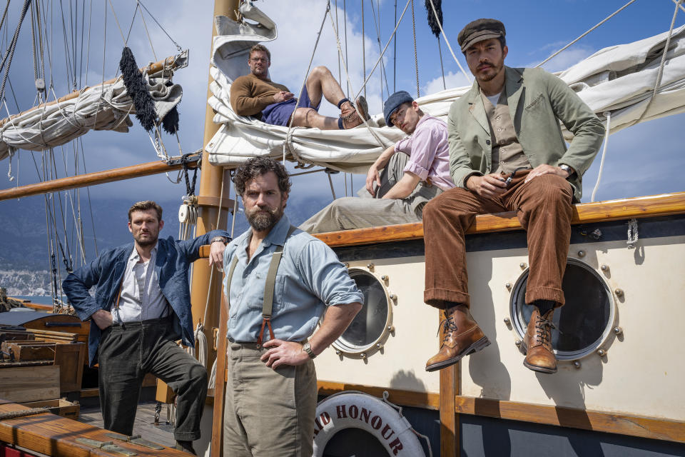 This image released by Lionsgate shows, from left, Alex Pettyfer, Henry Cavill, foreground center, Alan Ritchson, background center, Hero Fiennes Tiffin and Henry Golding in a scene from "The Ministry of Ungentlemanly Warfare." (Daniel Smith/Lionsgate via AP)