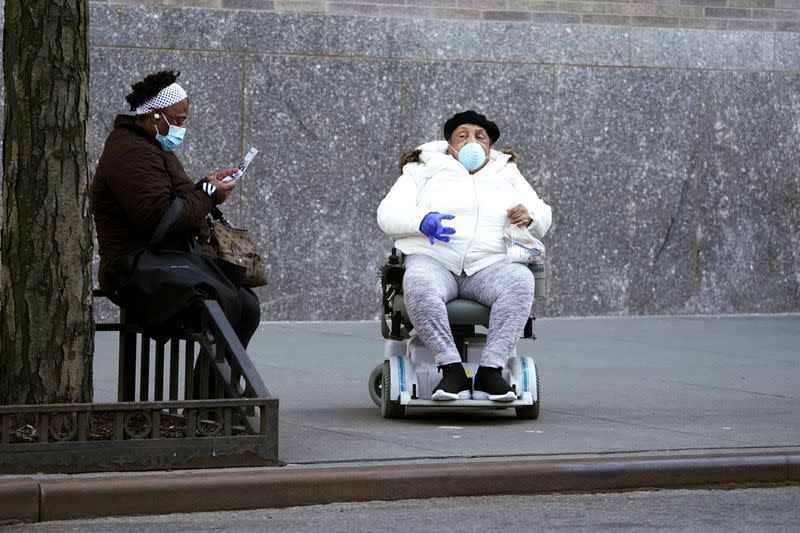 People sit outside hospital during outbreak of COVID-19 in New York City