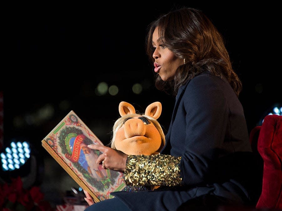 Michelle Obama and Miss Piggy read a book at the National Christmas Tree Lighting in 2015.