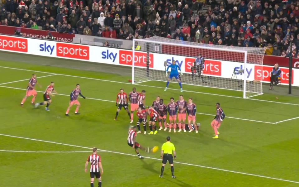 The change of ball position gives Ivan Toney a favourable angle to bend the ball around the wall