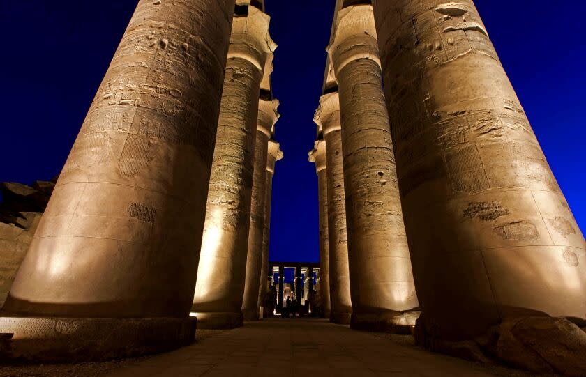 On this Wednesday, April, 30, 2014 photo, tourists visit Luxor Temple, a large ancient Egyptian temple complex on the east bank of the Nile River in Luxor, Egypt. Egyptian tourism officials, who Wednesday unveiled a replica of the tomb of King Tutankhamun in the desert valley where many of its ancient pharaohs were buried, are hoping the exhibit will help revive a tourism industry that has been heavily battered by the country's unrest since the 2011 uprising that toppled autocrat Hosni Mubarak. (AP Photo/Khalil Hamra)