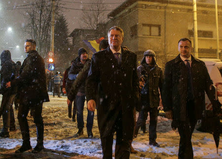 Romanian President Klaus Iohannis walks outside the Presidential Palace to speak to government supporters protesting in front of it, in Bucharest, Romania February 8, 2017. Inquam Photos/Octav Ganea via REUTERS