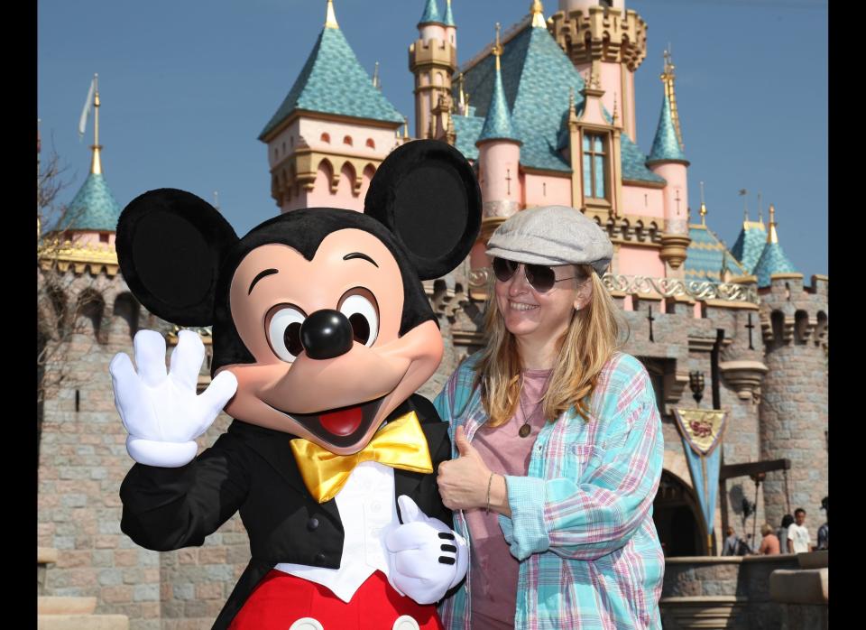 Melissa Etheridge meets Mickey Mouse in front of Sleeping Beauty Castle on February 18, 2010 at Disneyland in Anaheim, California.    (Photo by Paul Hiffmeyer/Disney via Getty Images)