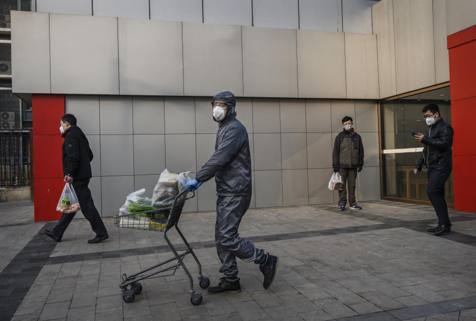 BEIJING, CHINA - FEBRUARY 11: A Chinese worker wears a protective suit and mask as he helps a customer to his car with his groceries at a supermarket on February 11, 2020 in Beijing, China. The number of cases of a deadly new coronavirus rose to more than 42000 in mainland China Tuesday, days after the World Health Organization (WHO) declared the outbreak a global public health emergency. China continued to lock down the city of Wuhan in an effort to contain the spread of the pneumonia-like disease which medicals experts have confirmed can be passed from human to human. In an unprecedented move, Chinese authorities have put travel restrictions on the city which is the epicentre of the virus and municipalities in other parts of the country affecting tens of millions of people. The number of those who have died from the virus in China climbed to over 1000 on Tuesday, mostly in Hubei province, and cases have been reported in other countries including the United States, Canada, Australia, Japan, South Korea, India, the United Kingdom, Germany, France and several others. The World Health Organization has warned all governments to be on alert and screening has been stepped up at airports around the world. Some countries, including the United States, have put restrictions on Chinese travellers entering and advised their citizens against travel to China. (Photo by Kevin Frayer/Getty Images)