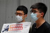 Pro-democracy activists Nathan Law and Joshua Wong speak to the media in response to the national security legislation in Hong Kong