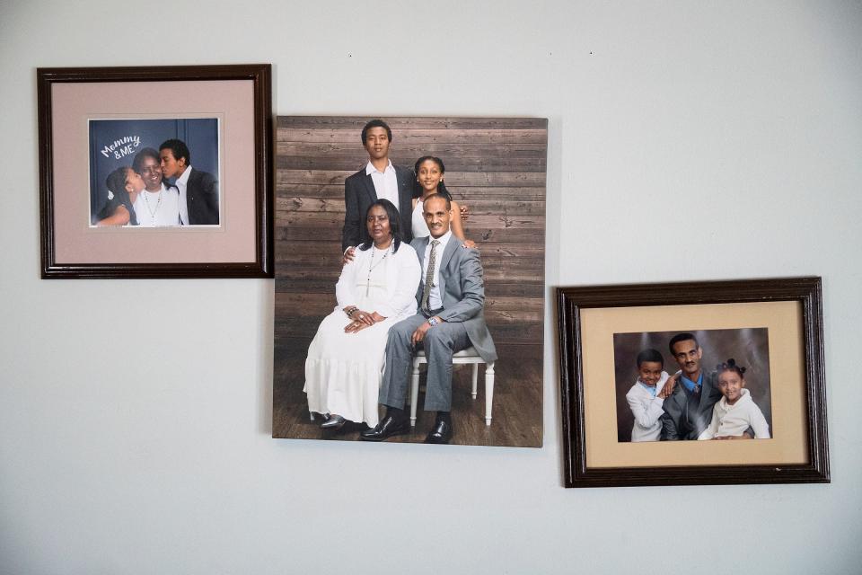 Photos of Mengsteab Aregay Gebremariam and his family hang on the wall of their west-side home Sunday, Jan. 16, 2022, in Indianapolis. 