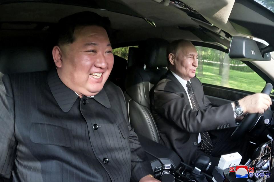 Russian President Vladimir Putin and North Korean leader Kim Jong Un drive a Russian Aurus limousine during their meeting in Pyongyang, North Korea, on Wednesday, June 19, 2024.