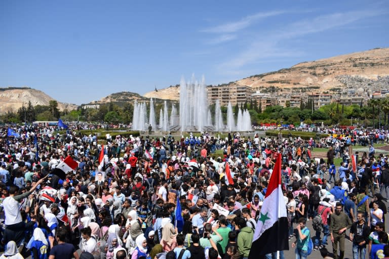 Syrians rally in Damascus' Omayyad square on April 16, 2018 in support of President Bashar al-Assad following Western air strikes against the regime over an alleged chemical attack