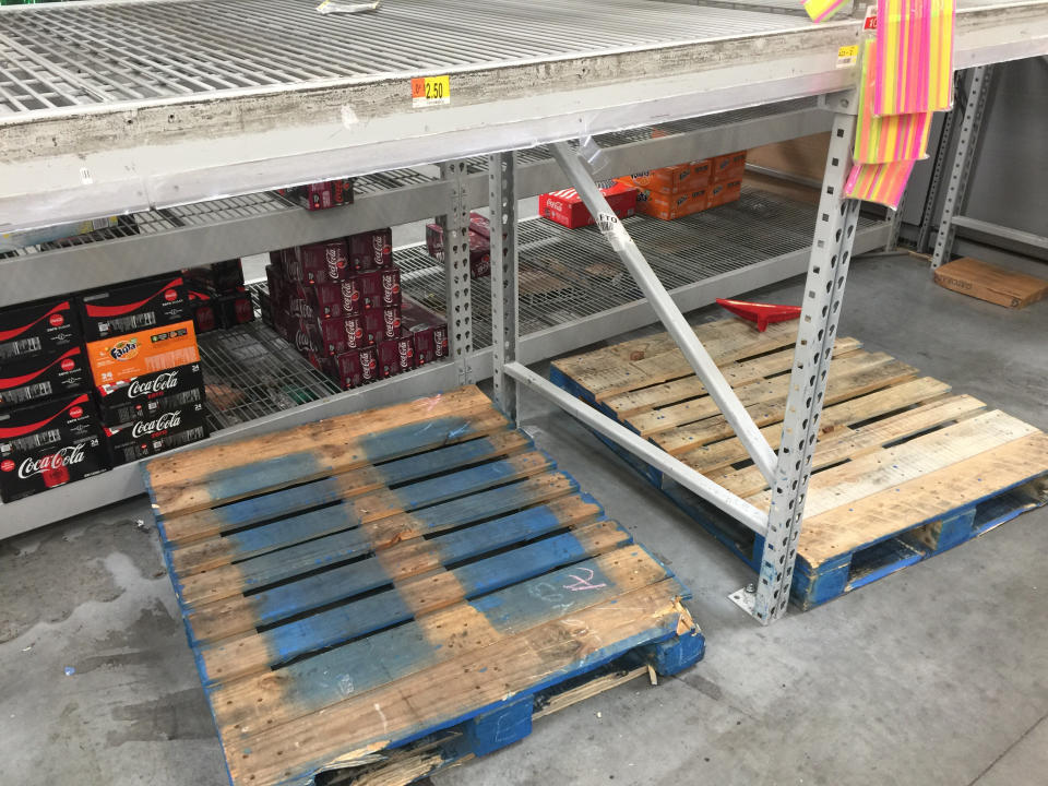 Wooden pallets and shelves that used to hold stacks of bottled water are empty at a Walmart in Fort Lauderdale on Wednesday. (Photo: Travis Waldron/HuffPost)