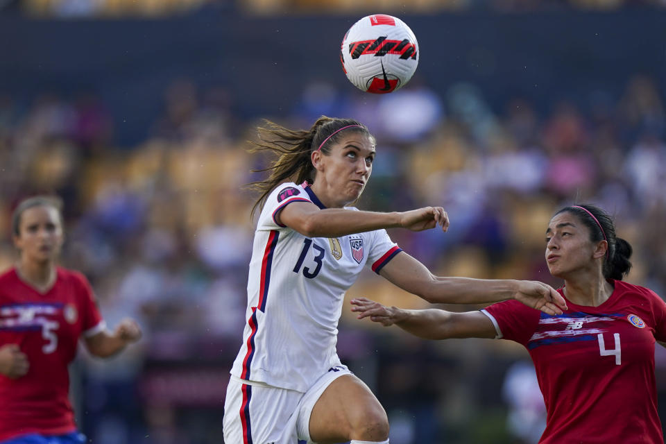 United States' Alex Morgan (13) and Costa Rica's Mariana Benavides fight for the ball during a CONCACAF Women's Championship soccer semifinal match in Monterrey, Mexico, Thursday, July 14, 2022. (AP Photo/Fernando Llano)