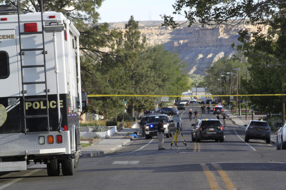 Investigators work along a residential street following a deadly shooting Monday, May 15, 2023, in Farmington, N.M. Authorities said an 18-year-old opened fire in the northwestern New Mexico community, killing multiple people and injuring others, before law enforcement fatally shot the suspect. (AP Photo/Susan Montoya Bryan)