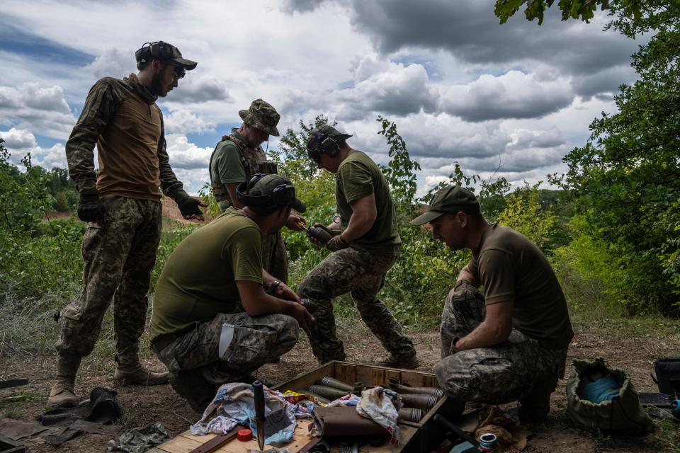 Ukrainian servicemen clean mortar shells during training in the Kharkiv region, Ukraine, Tuesday, July 19, 2022.