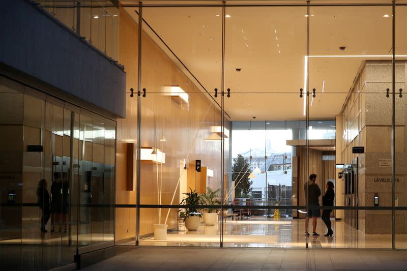 FILE PHOTO: People are seen on the ground floor of an office building in Sydney