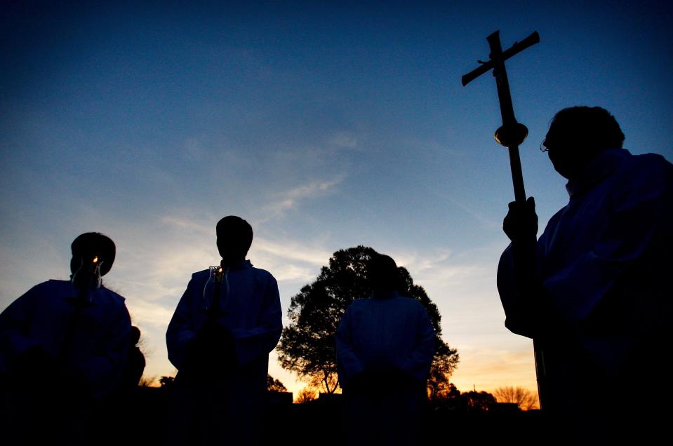 From left, brothers Matthew and Andrew Evangelisti hold candles while Bubba McArthur carries a crucifix as they prepare for the opening processional prior to an annual Easter Sunrise Mass at historic Calvary Cemetery on Elvis Presley Boulevard in Memphis, Tenn.
(Photo: The Commercial Appeal files)