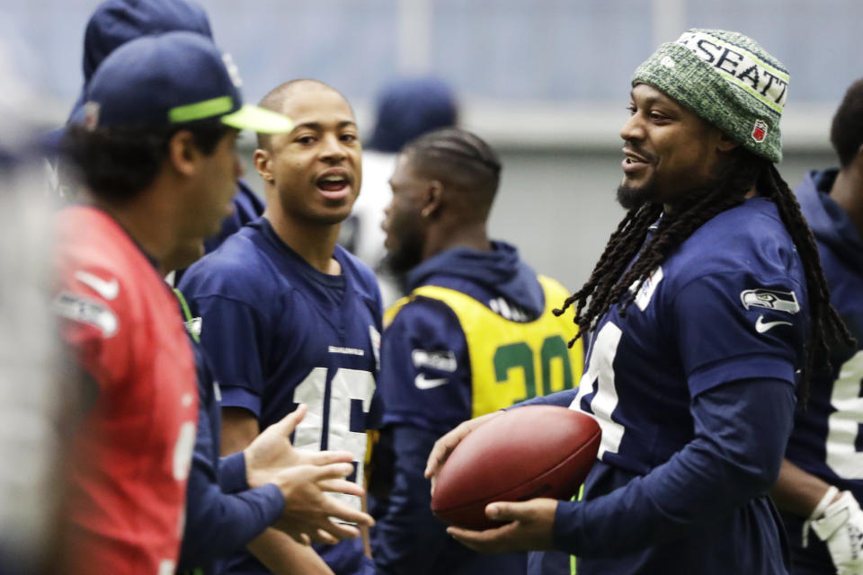 Seattle Seahawks running back Marshawn Lynch, right, warms up near quarterback Russell Wilson, left, and wide receiver Tyler Lockett, second from left, before NFL football practice, Friday, Dec. 27, 2019, in Renton, Wash. (AP Photo/Ted S. Warren)