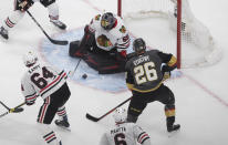 Chicago Blackhawks goalie Corey Crawford (50) makes the save on Vegas Golden Knights' Paul Stastny (26) during the second period in Game 1 of an NHL hockey Stanley Cup first-round playoff series, Tuesday, Aug. 11, 2020, in Edmonton, Alberta. (Jason Franson/The Canadian Press via AP)
