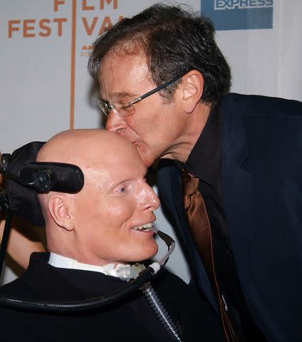 <p>Richard Corkery/NY Daily News Archive via Getty</p> Comic Robin Williams smooches pal Christopher Reeve's before a Tribeca Film Festival screening of "House of D"