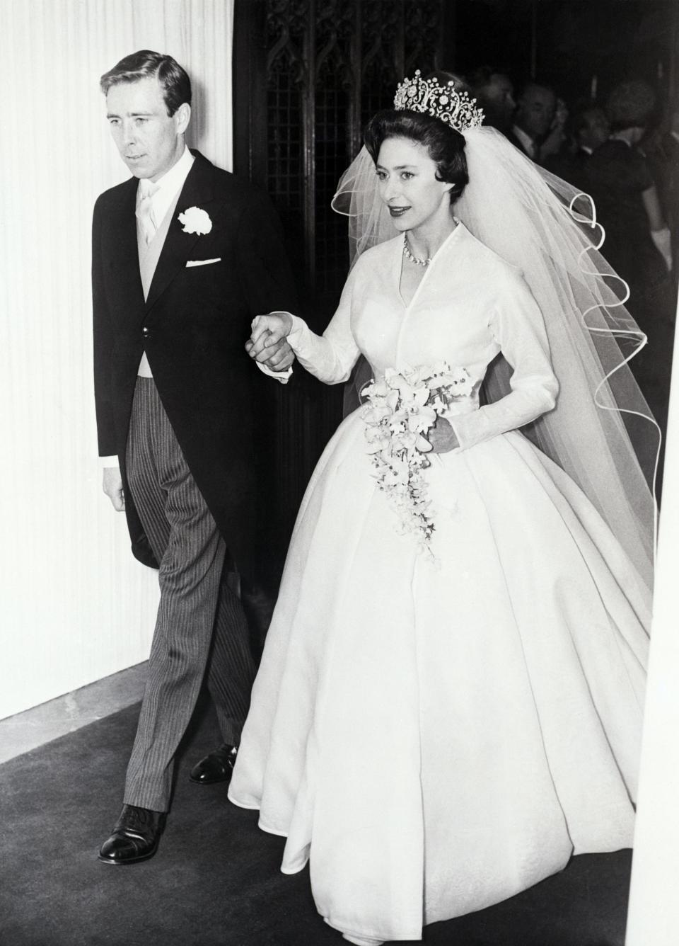 Princess Margaret wears a white gown with a v-neck on her wedding day in 1960.