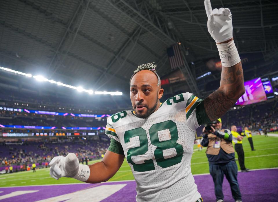 Dec 31, 2023; Minneapolis, Minnesota, USA; Green Bay Packers running back AJ Dillon (28) celebrates with fans wearing a Happy New Year headband after the game against the <a class="link " href="https://sports.yahoo.com/nfl/teams/minnesota/" data-i13n="sec:content-canvas;subsec:anchor_text;elm:context_link" data-ylk="slk:Minnesota Vikings;sec:content-canvas;subsec:anchor_text;elm:context_link;itc:0">Minnesota Vikings</a> at U.S. Bank Stadium. Mandatory Credit: Brad Rempel-USA TODAY Sports