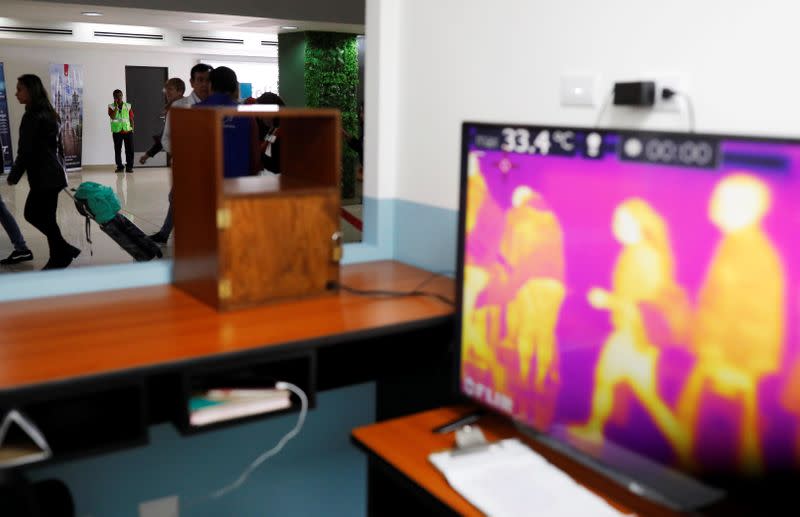 A general view shows the monitors of thermal scanners that detect temperatures of passengers at the security check inside the airport in Guatemala City