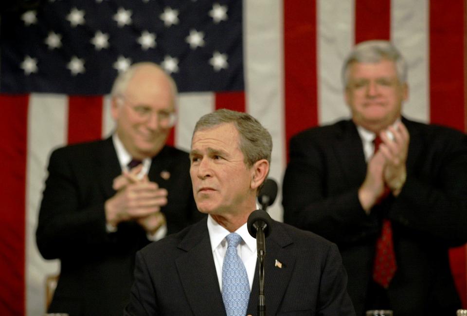 President Bush, center, flanked by Vice President Dick Cheney, left, and House Speaker Dennis Hastert, D-Ill., right, acknowledges applause in the House Chamber of the Capitol during Bush's State of the Union address to a joint session of Congress on Jan. 29, 2002, in Washington. Bush opened by saying, "As we gather tonight, our nation is at war, our economy is in recession, and the civilized world faces unprecedented dangers. Yet the state of our Union has never been stronger."