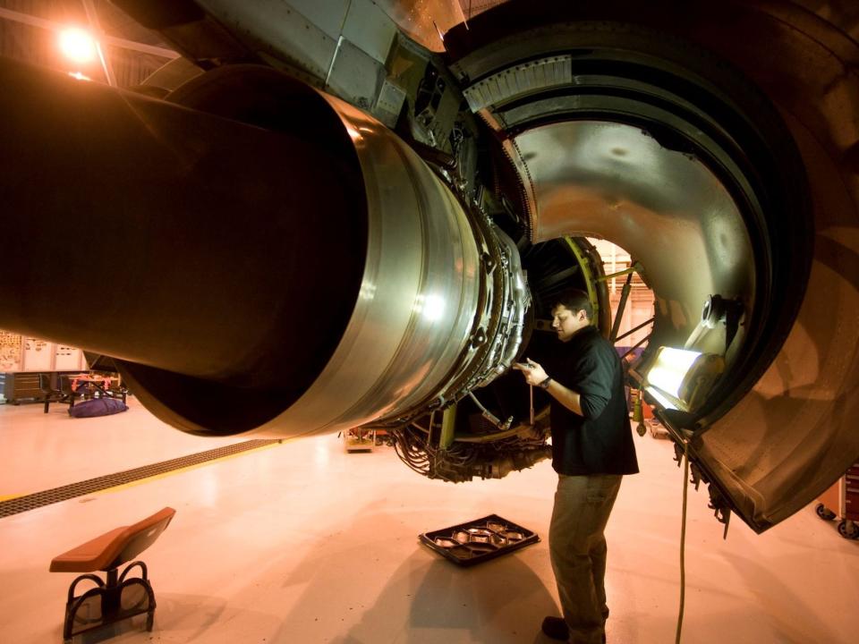 Travis Hunsicker, an aircraft mechanic assigned to the 55th Maintenance Squadron at Offutt Airforce Base in Bellevue, Nebraska, works on the engine of a RC-135 Rivet Joint aircraft, Tuesday, November 25, 2008.