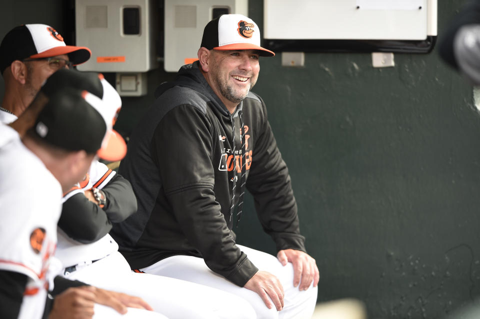 FILE - In this Tuesday, April 9, 2019 file photo, Baltimore Orioles manager Brandon Hyde sits in the dugout before playing the Oakland Athletics in a baseball game in Baltimore. There might come a time when Brandon Hyde wakes up in the morning, grabs a newspaper and checks out the standings to see where the Baltimore Orioles stand. For now, the rookie manager simply can’t bear to look. The rebuilding Orioles limped into the All-Star break with a major league worst 27-62 record. (AP Photo/Gail Burton, File)
