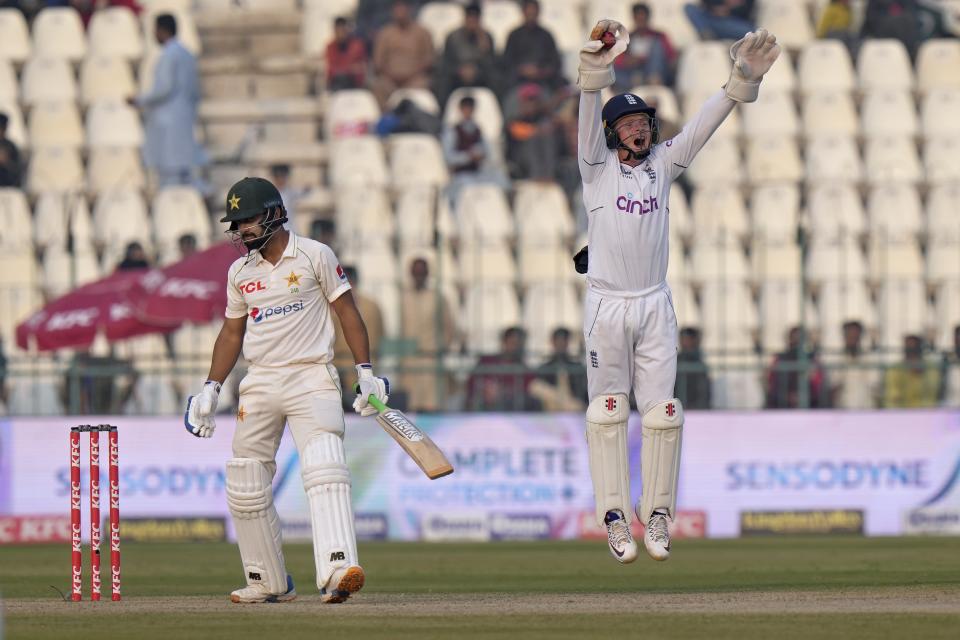 England's Ollie Pope, right, appeals successfully catch out of Pakistan's Abdullah Shafique, left, during the first day of the second test cricket match between Pakistan and England, in Multan, Pakistan, Friday, Dec. 9, 2022. (AP Photo/Anjum Naveed)