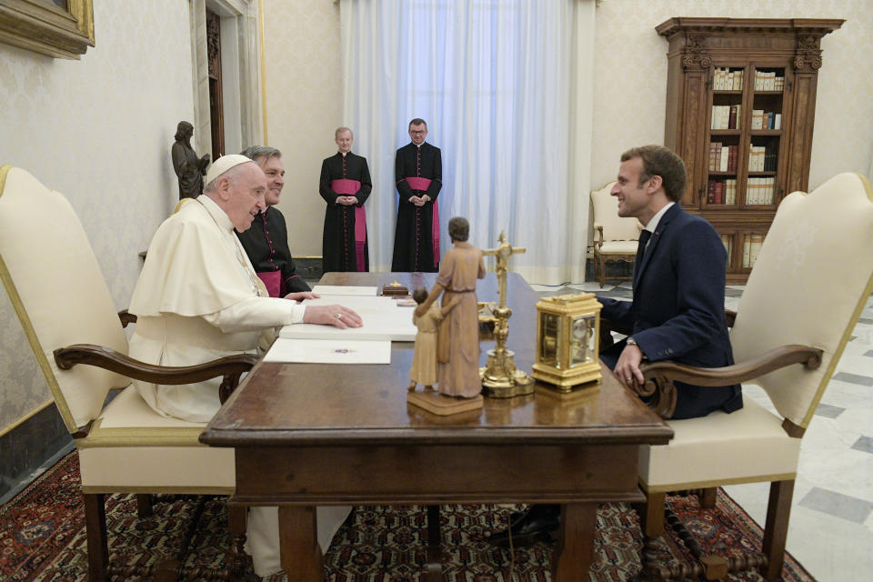 French President Emmanuel Macron, right, talks with Pope Francis during a private audience at the Vatican, Friday, Nov. 26, 2021. (Vatican Media via AP)